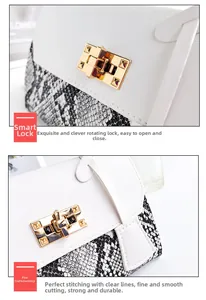 Macro detail of golden twist lock and snake skin pattern on the stylish white handbag