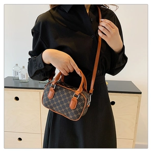 Detailed top view of a mini brown vintage boston barrel bag with adjustable strap