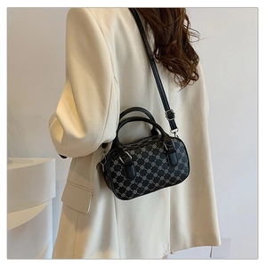 Chic black and white clover pattern Boston bag shown on model for elegant daily commute
