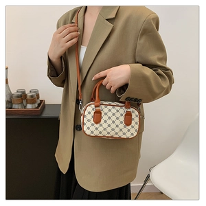 Chic retro Boston bag with vintage floral print shown on model in khaki blazer suit