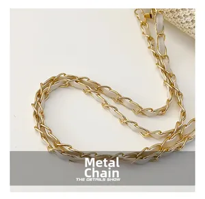 Detail of gold metal hardware chain woven with white leather on a straw handbag