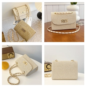 Detail view showing straw woven crossbody bag with metal chain strap and twist lock closure