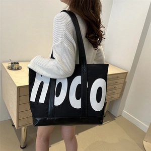 Fashionable black lightweight tote bag with white hpco letters and leather strap