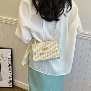 Chic beige straw woven crossbody bag with gold chain strap and metallic lock closure