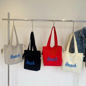 Canvas beach tote bags with letter print in grey, black, red, and beige colors