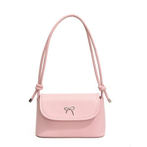 Pink matte leather crossbody bag with silver bow accent and adjustable rope straps