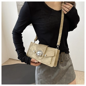 Side view of model wearing a vintage beige crossbody square bag with Saturn logo metal buckle