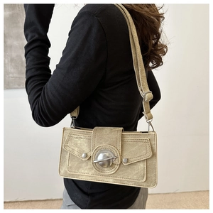 Detail of beige vintage canvas crossbody bag with adjustable strap and metal buckles