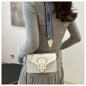 Detailed back view of a minimalist white leather crossbody bag with a wide buckled flap