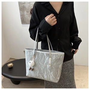 Silver pleated tote bag with chic bamboo texture and plush pendant in high-quality style
