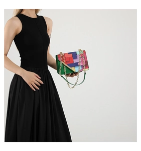 Close-up of colorful geometric pattern handbag with a golden metal chain strap
