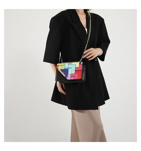 Chic patchwork chain bag with colorful geometric blocks shown on model's shoulder