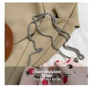 Detail showing the silver chain strap and pink strawberry corduroy bucket bag texture