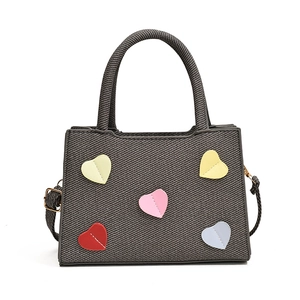 Chic canvas bucket bag with colorful heart patches and woven handle for summer casual style
