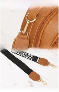 Detail of high-polish gold vacuum-plated hardware and letter print woven wide strap