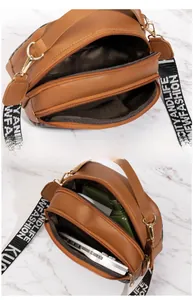 Internal view of brown quilted crossbody bag with three zipper compartments and broad strap