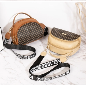 Close-up of saddle bag with dual zipper compartments and patterned print details