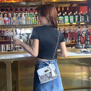 Elegant white crossbody bag with snakeskin pattern, gold lock and chain strap for women