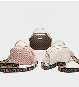 Close-up of shell-shaped handbags in three colors with printed wide LOVE straps