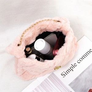 Pink fluffy faux fur chain crossbody bag showing large interior capacity for cosmetics