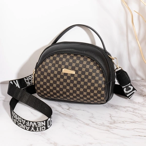 Quilted shell crossbody bag with retro monogram pattern and wide textile shoulder strap
