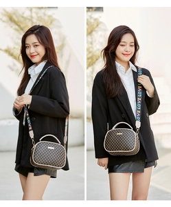 Detail of vintage check crossbody bag with colorful LOVE patterned woven shoulder strap