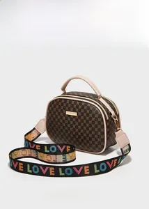 Detail view of coffee-colored geometric print handbag with stylish logo fabric strap