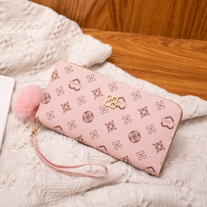 Pink floral printed long wallet for women with golden flower clasp and pompom keychain