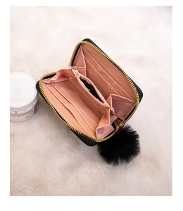 Inside view of black rivet purse with pink lining, card slots and coin compartment