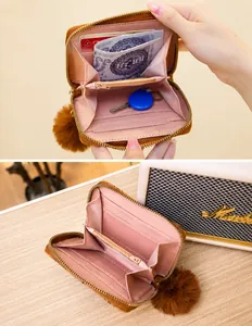 Detailed interior of a printed short wallet with multiple card slots and a pompom charm