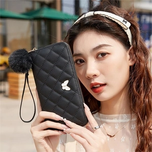 Quilted black long wallet with butterfly decor, pompom keychain and wrist strap