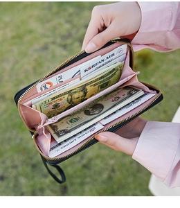 Close-up of black long wallet featuring multiple card slots and pink lining interior