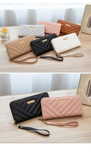 Close-up of quilted long zip wallets with chevron stitching and detachable wrist strap