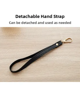 Detail of detachable black leather wrist strap with golden metal lobster clasp