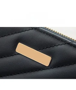 Detailed close-up of premium black leather wallet texture with gold hardware accent