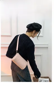 Floral barrel crossbody bag with adjustable pink strap worn by an Asian model