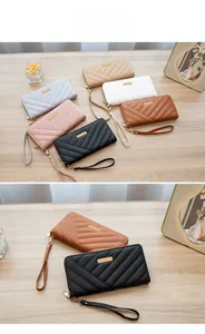 Close-up of women's long quilted wallets with V-pattern stitching and gold metal plates