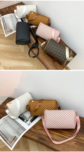 Close-up of stylish cylinder bags with floral patterns and adjustable wide straps