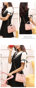 Detail shot of pink quilted mini bag with golden chain strap and smooth zipper slider