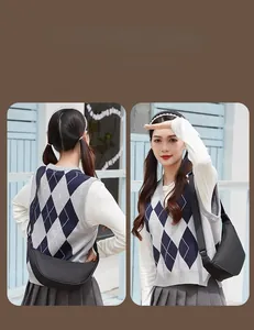 Detail view of a black crescent crossbody bag with adjustable wide fabric strap