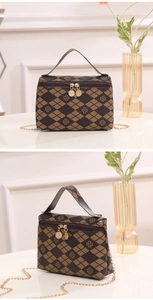 Detail of vintage rhombic handbag with golden clover prints and dual metal zippers