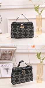 Detailed view of black and gray rhombic cosmetic bag with clover print and gold metal chain