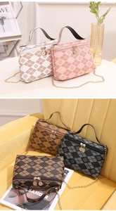 Detail of color-block quilted handbags with clover print and gold chain straps