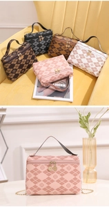 Detail view of pink quilted cosmetic bag with clover pattern and metal chain