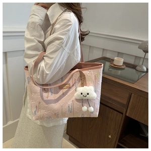 Detail of pink jacquard tote bag with wavy embroidery and fluffy cloud charm