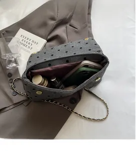Macro detail of spacious interior in grey woolen chain tote bag showing large storage capacity