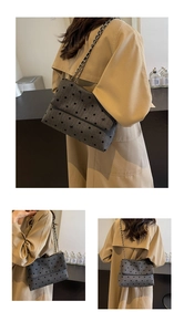Detailed view of the dark grey polka dot tote bag with chain strap and bow embroidery