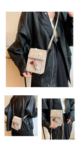 Detail view of beige crossbody phone bag featuring colorful heart patches and knot strap
