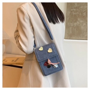 Blue denim mini crossbody phone bag with heart decorations and pink bow knot detail