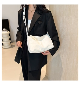 Detail of white nylon tote bag with pleated texture and adjustable wide shoulder strap